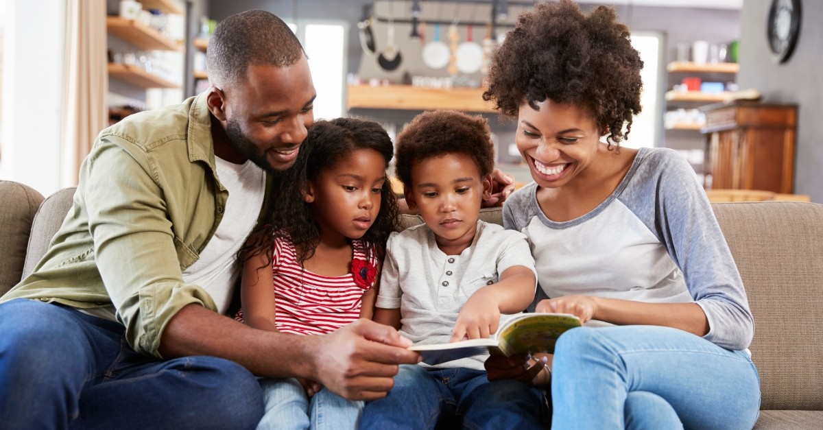 Family reading on the couch together