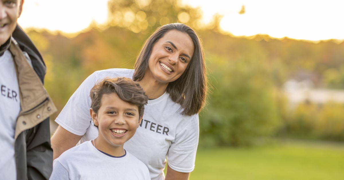 Happy family volunteering together in the fall