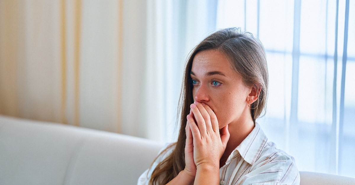 Woman looking anxious on the couch